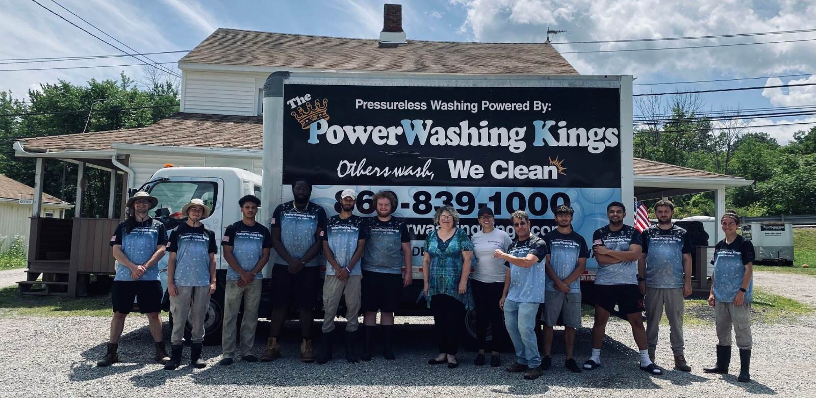 The Powerwashing Kings team standing in front of a pressure-washing truck